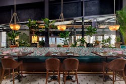 The dining room at Grizform&rsquo;s Dauphine&rsquo;s in Washington D.C. is filled with lush greenery.