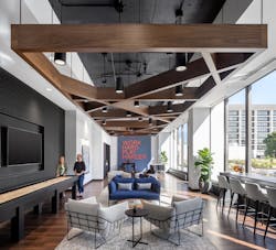 A warm, inviting game room replaced a general convenience store on the ground floor and features shuffleboard and a foosball table, plus comfortable seating where employees can take a break and recharge. A warm, inviting game room replaced a general convenience store on the ground floor and features shuffleboard and a foosball table, plus comfortable seating where employees can take a break and recharge.