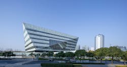From the exterior, the library appears to “float” above two pavilions—one housing a 1,200-seat theater, exhibition, and events space; the other housing a children’s library with a central courtyard and outdoor play spaces. From the exterior, the library appears to “float” above two pavilions—one housing a 1,200-seat theater, exhibition, and events space; the other housing a children’s library with a central courtyard and outdoor play spaces.