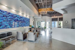 The Samaritan Inn&apos;s blue color is incorporated throughout the project, from the blue wainscot wrapping around each building to the Good Samaritan brick wall in the lobby paying homage to its generous supporters.