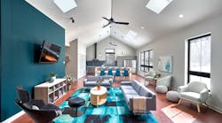 The design turned a formerly dark, dingy living room into a large, open, light-filled space thanks to the expansive windows and skylights, with rich, deep teal accents that extend from the great room to the kitchen beyond. The design turned a formerly dark, dingy living room into a large, open, light-filled space thanks to the expansive windows and skylights, with rich, deep teal accents that extend from the great room to the kitchen beyond.