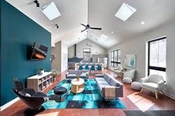 The design turned a formerly dark, dingy living room into a large, open, light-filled space thanks to the expansive windows and skylights, with rich, deep teal accents that extend from the great room to the kitchen beyond. The design turned a formerly dark, dingy living room into a large, open, light-filled space thanks to the expansive windows and skylights, with rich, deep teal accents that extend from the great room to the kitchen beyond.