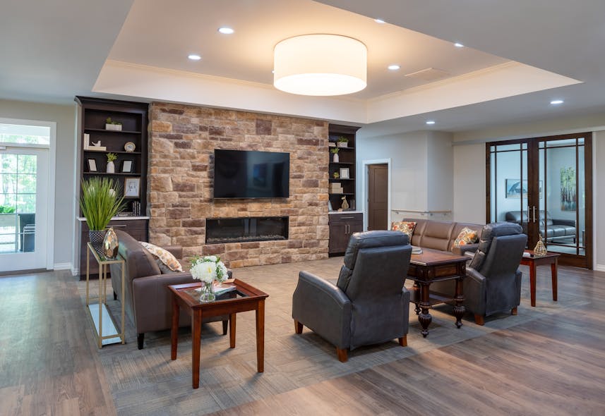 A warm, inviting living room space is utilized by residents and family, as well as staff.