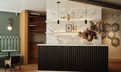 The tasting room welcomes with a rustic nature, highlighting decorative honeycomb shapes peek-a-booing behind reception.