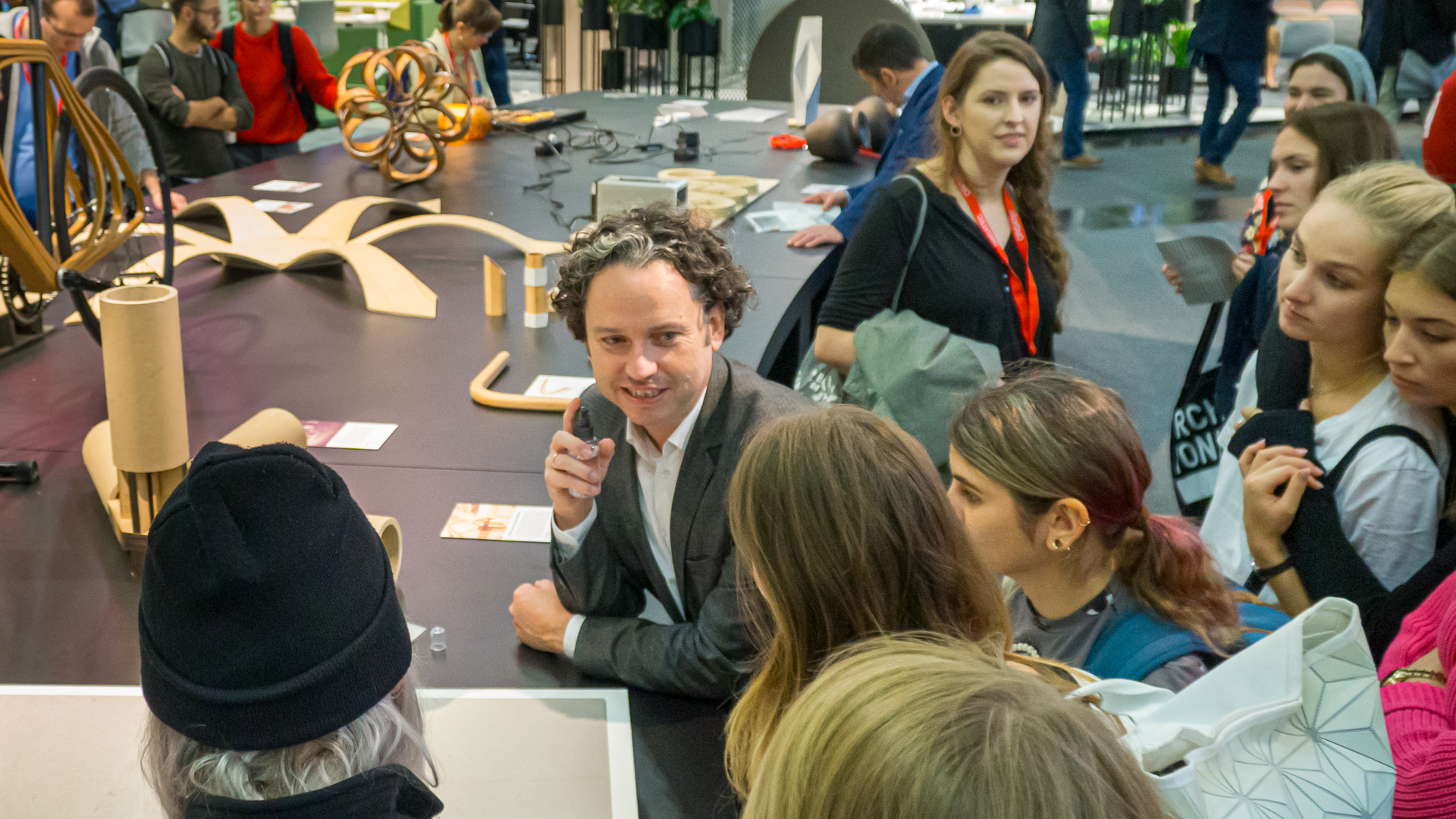 Dr. Sasha Peters, Haute Innovation, with students in his material innovations exhibit at Orgatec.