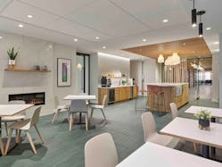 FCA was still able to increase the number of thoughtfully designed areas to accommodate differing team members&rsquo; needs and work styles, with contemplative areas for heads-down work such as this lounge space with a kitchen area and fire feature.