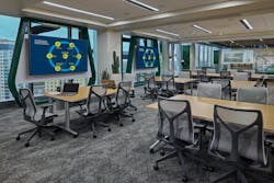 Softening this pod of unassigned stations at Novelis, biophilic elements include outdoor views, plants, green accents and wood tones. Softening this pod of unassigned stations at Novelis, biophilic elements include outdoor views, plants, green accents and wood tones.