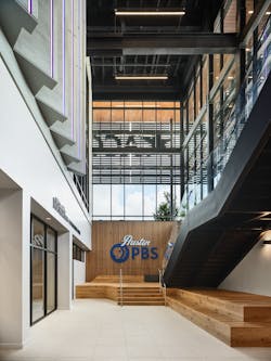 Daylight is a commodity for Austin PBS, which is a partial subterranean space. The main staircase and lobby are located along a two-story bank of windows with the station&rsquo;s first-ever sign.