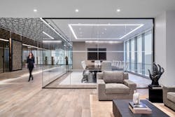 The entry area screams sophistication with a warm, neutral color palette and glass-enclosed conference room. TMA also utilized mirrors again in the corridor to further play with space volume.