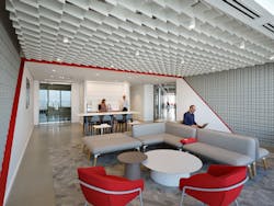 The entry is comprised of a lounge and coffee bar, accentuated by MKG&apos;s signature pops of red.
