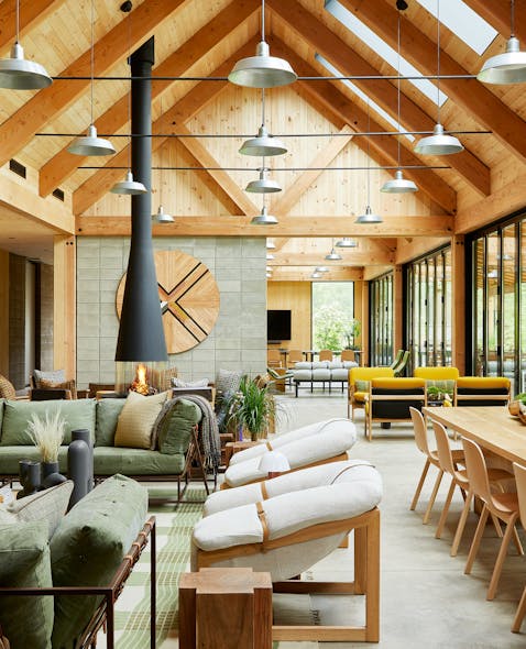 The AutoCamp Catskills Clubhouse location is furnished with pieces that bring outdoor hospitality indoors and highlights the three materials in a timber frame, exposed concrete block and Douglas Fir pine.