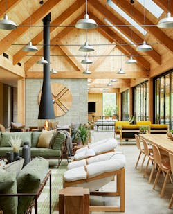 The AutoCamp Catskills Clubhouse location is furnished with pieces that bring outdoor hospitality indoors and highlights the three materials in a timber frame, exposed concrete block and Douglas Fir pine.