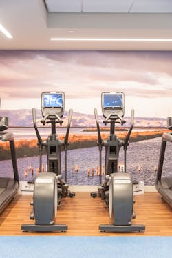 The fitness center features a floor to ceiling image of Mission Bay. The fitness center features a floor to ceiling image of Mission Bay.