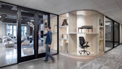 The new Acre office and showroom entrance features a curved glass product showcase framed by subtle colors to make the pieces the focal point. The new Acre office and showroom entrance features a curved glass product showcase framed by subtle colors to make the pieces the focal point.