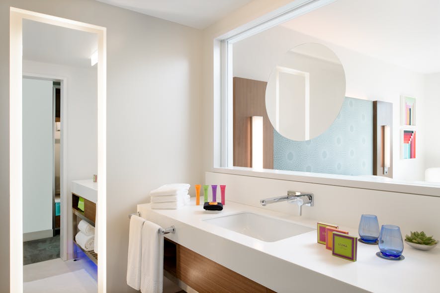 Details like direction of the mirror and the location of the faucet create a cleaner, more spacious feeling in the guestrooms.