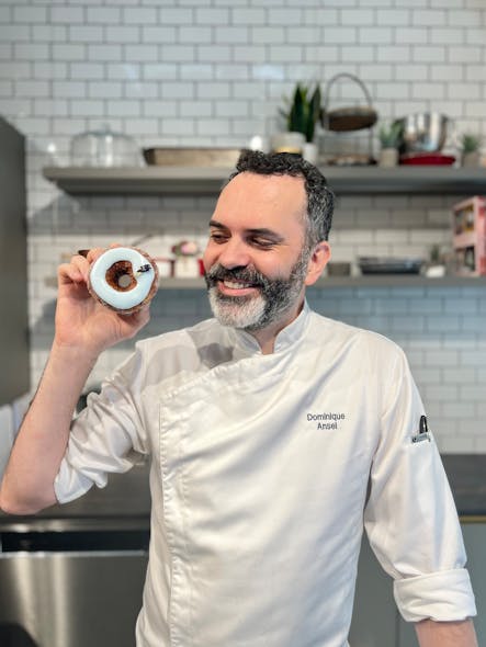 James Beard Award-winning French pastry chef Dominique Ansel holds his vegan Cronut inspired by Sherwin-Williams&apos; Color of the Year.