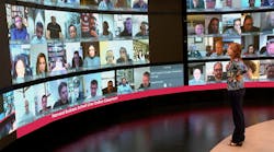 Harvard Business School Executive Education students are displayed prominently on a super large high-definition screen in a broadcast studio-quality Live Online Classroom in Boston.
