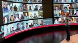Harvard Business School Executive Education students are displayed prominently on a super large high-definition screen in a broadcast studio-quality Live Online Classroom in Boston.