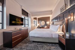 HBA Los Angeles renovated The Dagny Boston Hotel with guest rooms featuring wainscoting accents in handsome blue. This superior king room has build-in reading lights and woven and leather-like fabric wraps on the furniture. HBA Los Angeles renovated The Dagny Boston Hotel with guest rooms featuring wainscoting accents in handsome blue. This superior king room has build-in reading lights and woven and leather-like fabric wraps on the furniture.