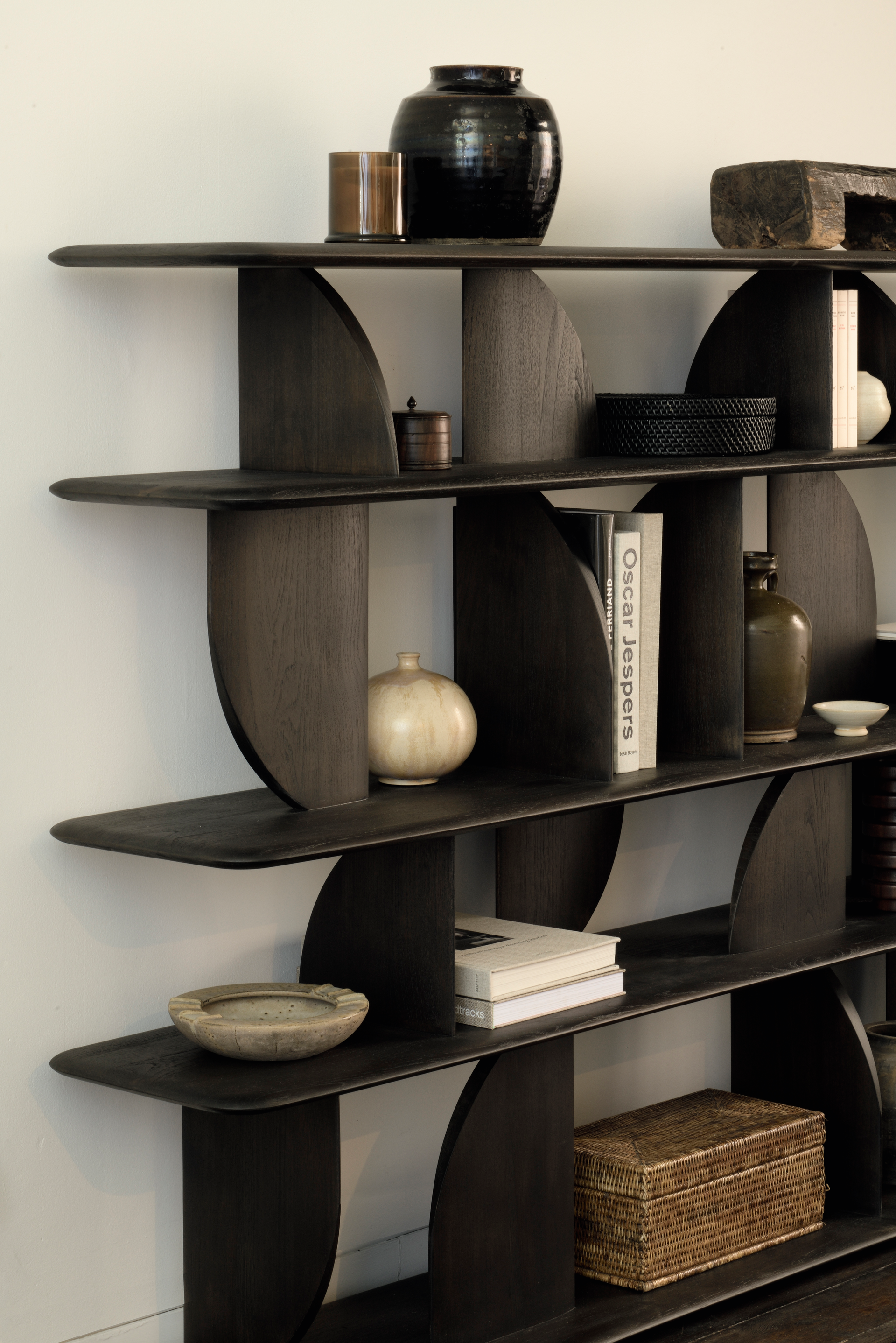 The Geometric rack is crafted in solid wood teak with a rich dark brown finish.
