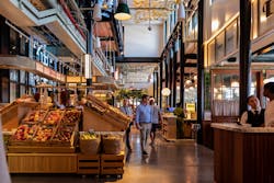 Restored cast iron columns, recreated vintage signage and light fixtures are showcased at this vegetable stand and fish counter in the main market area. Restored cast iron columns, recreated vintage signage and light fixtures are showcased at this vegetable stand and fish counter in the main market area.