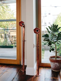 Copper speaking tubes, a unique element within Aizaki&apos;s home.