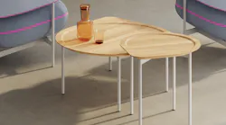 The Posie table is available in three sizes. These nesting tables have a round, recessed top within a teardrop outline.