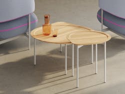 The Posie table is available in three sizes. These nesting tables have a round, recessed top within a teardrop outline.