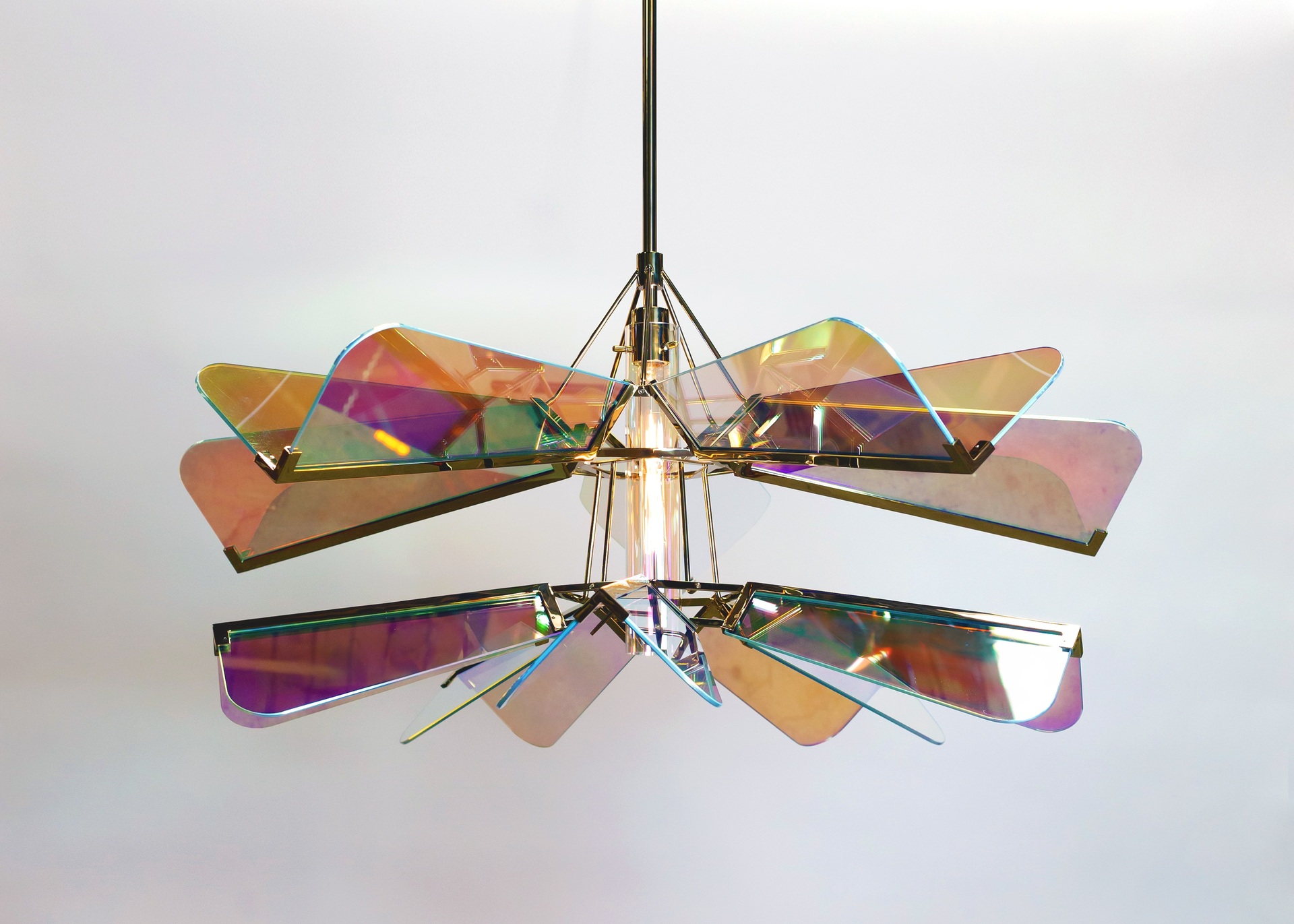 The undulating, multi-colored waves of the Arco chandelier cast beautiful shadows over the interior below.