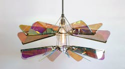 The undulating, multi-colored waves of the Arco chandelier cast beautiful shadows over the interior below.