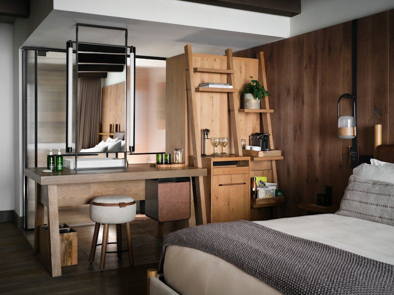 The vanity, mini bar and closet can be accessed from both bathroom and bedroom side of the guest room, inspired by a large farm table that all can easily surround.