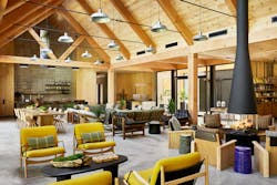 Clubhouse decor is described as 'mid-century yet campy' with fun pops of yellow, and unique details like belts, buckles, and homemade elements. Clubhouse decor is described as 'mid-century yet campy' with fun pops of yellow, and unique details like belts, buckles, and homemade elements.