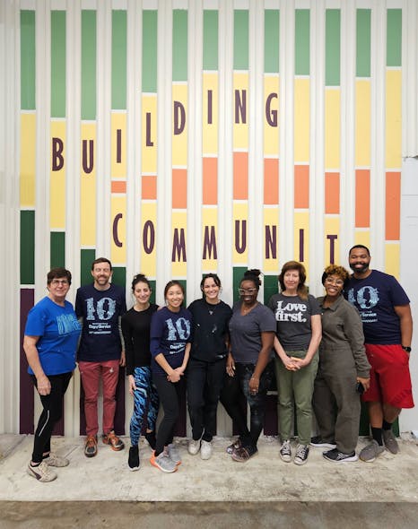 EskewDumezRipple and accompanying firm volunteers paint murals at the New Orleans warehouse for the organization Second Harvest Food Bank during the firm&rsquo;s 10th Anniversary of the Martin Luther King, Jr. Day of Service.