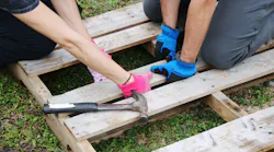 EskewDumezRipple and accompanying firm volunteers construct vertical planters from recycled pallets for New Orleans organization Hollygrove-Dixon Neighborhood Association during the firm’s 10th Anniversary of the Martin Luther King, Jr. Day of Service.