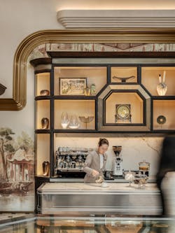 The display shelving behind the custom coffee bar mimics the Lingnan architecture featured in the Allom illustrations that can be found throughout Cake Shop.