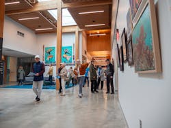 The community walks past the art wall during the grand opening of the Redmond Senior & Community Center. The space features a skylight and an exposed wood ceiling, highlighting the biophilic design of the center. The community walks past the art wall during the grand opening of the Redmond Senior & Community Center. The space features a skylight and an exposed wood ceiling, highlighting the biophilic design of the center.