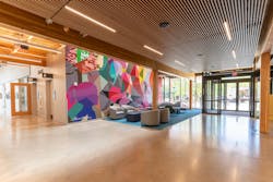 A two-story, community-painted mural welcomes visitors to the Redmond Senior & Community Center lobby. The mural, titled “Altogether,” is by Mauricio Ramirez and extends into the second-floor weight room. A two-story, community-painted mural welcomes visitors to the Redmond Senior & Community Center lobby. The mural, titled “Altogether,” is by Mauricio Ramirez and extends into the second-floor weight room.