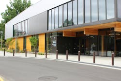 The entrance to the Redmond Senior & Community Center, located at 8703 160th Ave. NE in Redmond, Washington, features mass plywood panels, and wood and metal siding relegated to the second floor. Large windows offer street views into the weight room. The entrance to the Redmond Senior & Community Center, located at 8703 160th Ave. NE in Redmond, Washington, features mass plywood panels, and wood and metal siding relegated to the second floor. Large windows offer street views into the weight room.