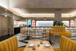 While the bar area at Baleia feels more intimate and enclosed with its lower ceiling (above left), a full-height ceiling and netted copper-chain lighting installation create a sense of grandeur in the main dining area (below left). While the bar area at Baleia feels more intimate and enclosed with its lower ceiling (above left), a full-height ceiling and netted copper-chain lighting installation create a sense of grandeur in the main dining area (below left).