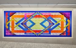 At the Pacific Park Campus of IS 653, the 18-foot printed glass mural 'Remember When Tomorrow Came' was designed to capture students' attention with its bold colors. At the Pacific Park Campus of IS 653, the 18-foot printed glass mural 'Remember When Tomorrow Came' was designed to capture students' attention with its bold colors.