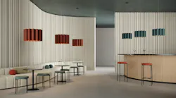 Luxxbox's Kurtain acoustic pendant suspended over a bar and lounge seating.