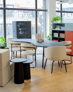 Image of furniture showroom in NYC with wood flooring, and various seating around conference room table and storage. Image of furniture showroom in NYC with wood flooring, and various seating around conference room table and storage.