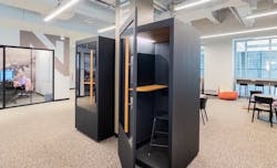 A set of privacy pods/phone booths with offices in the background. A set of privacy pods/phone booths with offices in the background.