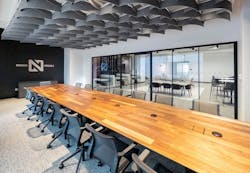Long, wooden conference table with modern chairs and acoustic baffles in the ceiling. Long, wooden conference table with modern chairs and acoustic baffles in the ceiling.