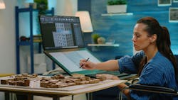 Interior designer drafting a concept layout Interior designer drafting a concept layout