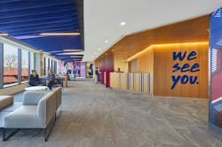 Bright, daylit lobby with lounge seating, wood-paneled walls and a large, blue 'we see you' graphic. Bright, daylit lobby with lounge seating, wood-paneled walls and a large, blue 'we see you' graphic.