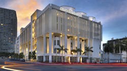 Street level view of exterior facade of Care Resource health center in Miami at dusk. Street level view of exterior facade of Care Resource health center in Miami at dusk.