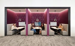 HGA employees work in booths adorned with a plum-colored backdrop, a signature hue of the company's branding. HGA employees work in booths adorned with a plum-colored backdrop, a signature hue of the company's branding.