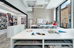 The finish library features shelving hanging from a structural beam and set up onto a beam to support the weight of the shelves on the wrap floor. The finish library features shelving hanging from a structural beam and set up onto a beam to support the weight of the shelves on the wrap floor.