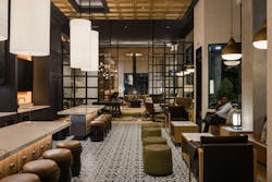 Clean lined traditional cabinetry, oversized pendant lights, and modern round stools create a classic ambience in the Midland Lofts entertainment kitchen amenity space. Clean lined traditional cabinetry, oversized pendant lights, and modern round stools create a classic ambience in the Midland Lofts entertainment kitchen amenity space.